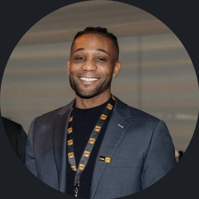 Steevens smiling in a blazer at a corporate event