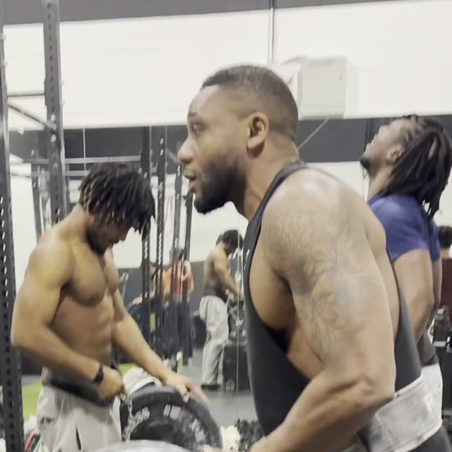 Steevens in the gym, wearing a weight belt